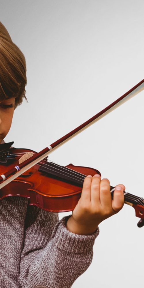 boy-against-grey-background-playing-violin-v6